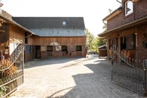 a brick building with a gate in front of it at Zimmer auf Bauernhof in Kürten