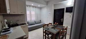 a kitchen and a dining room with a table and chairs at Imeros Summer Home in Ímeros +10 photos