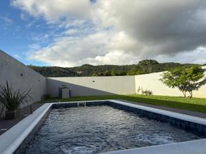 a swimming pool in the backyard of a house at Escobar Sunset in Paraguarí