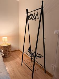 a room with a black clothes rack in a bedroom at Sunset holiday house in Liepāja