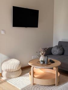 a living room with a table and a couch at Sunset holiday house in Liepāja