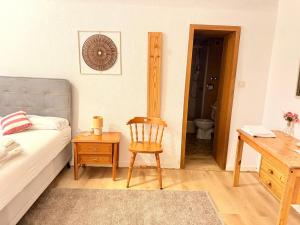 a bedroom with a bed and a desk and a chair at Hotel Dreischläger Hof in Fernthal