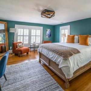 a bedroom with a large bed with blue walls at Hellbender Bed & Beverage in Blowing Rock
