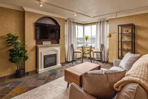 a living room with a couch and a fireplace at Downtown Condo Epic Views in Anchorage