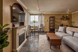 a living room with a couch and a fireplace at Downtown Condo Epic Views in Anchorage