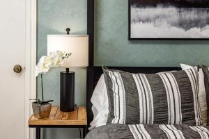 a bedroom with a bed and a lamp on a table at Downtown Condo Epic Views in Anchorage