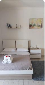 a bedroom with two beds with towels on them at Kıbrısın gözdesi Long Beach de Havuz manzaralı stüdyo daire in Trikomo +13 photos