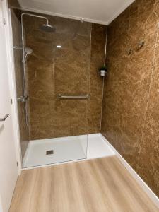 a shower with a glass door in a bathroom at Casa Vilela in Arzúa +8 photos