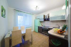 a kitchen with a table with a bowl of fruit on it at PaulMarie Apartments on Chehova in Mogilev
