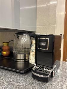 a kitchen counter with a food processor and a blender at Luxury Stay in Cairo in Sheikh Zayed