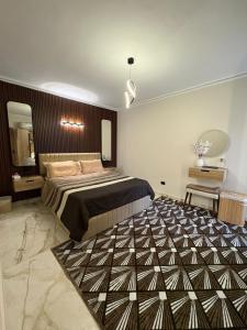 a bedroom with a large bed and a large rug at Luxury Stay in Cairo in Sheikh Zayed