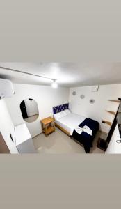 a small room with a bed and a desk at ARY Hotel in Valledupar