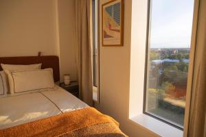 a bedroom with a bed and a window at Designer apartment with city view in Copenhagen