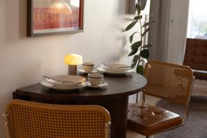 a wooden table with cups and saucers on it at Designer apartment with city view in Copenhagen