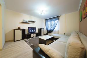 a living room with a couch and a tv at PaulMarie Apartments on Chehova in Mogilev