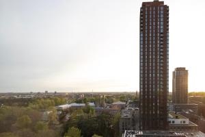 a view of a city with a tall building at Designer apartment with city view in Copenhagen