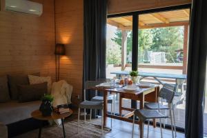 a living room with a table and chairs and a couch at Natura Domki Anastazewo in Anastazewo +83 photos
