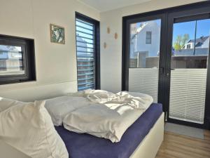 a bed in a room with a large window at Floating Comfort in Peenemünde in Peenemünde