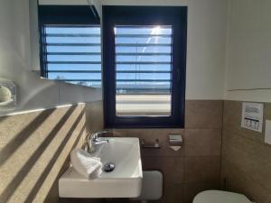 a bathroom with a sink and a window and a toilet at Floating Comfort in Peenemünde in Peenemünde +31 photos