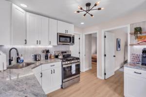 a kitchen with white cabinets and stainless steel appliances at Prof Cleaned | Linen+Towel | Pet Friendly | Coffee in Seaside Heights