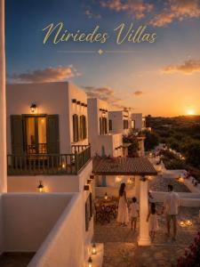 a family walking on the balcony of a house with the sunset at Niriedes Villas in Leipsoi