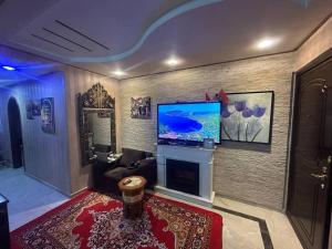 a living room with a flat screen tv on a wall at Stars Hostel Tangier in Tangier