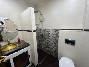 a bathroom with a sink and a shower at Stars Hostel Tangier in Tangier +17 photos