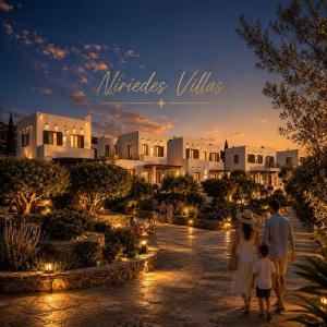 a family walking in front of a villa at sunset at Niriedes Villas in Leipsoi