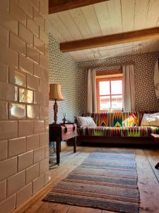 a living room with a couch and a window at Siedlisko Leśny Jaśmin in Łuka