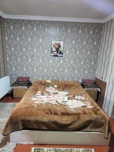 a bedroom with a large bed with flowers on it at Shabran Pearl Oasis - Family Garden House - Ailəvi Bağ Evi in Surra +78 photos