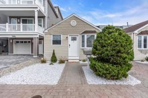 a house with a tree in front of it at Prof Cleaned | Linen+Towel | Pet Friendly | Coffee in Seaside Heights +7 photos