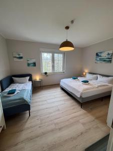 a bedroom with two beds and a large window at Seeblick Apartments Mühlau in Mühlau