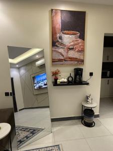 a room with a painting on the wall and a table at استوديو حي حطين in Riyadh +4 photos