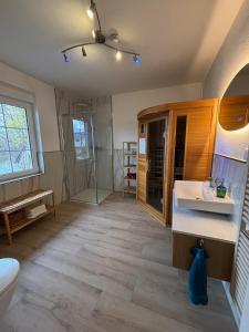 a bathroom with a toilet and a sink and a tub at Seeblick Apartments Mühlau in Mühlau +99 photos