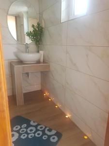 a bathroom with a sink and a mirror at Takis Haikos House two minutes walk to the beach Peroulia in Vounaria
