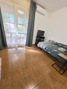 a bedroom with a bed and a large window at Appartamento Silva in Gorizia
