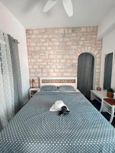 a bedroom with a bed with a hat on it at Central Parikia stay-Helios in Parikia