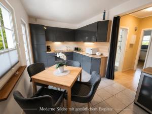 a kitchen with a wooden table and chairs in a room at Ostseeferienhaus Usedom Lütow am Achterwasser Hundefreundlich Naturlage Familie Christian Ziethen in Lütow