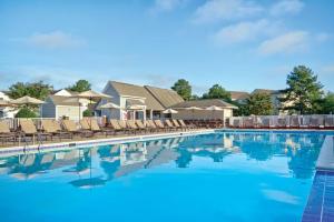 a swimming pool at a resort with chairs at Kingsgate Resort 1BR Apartment in Williamsburg