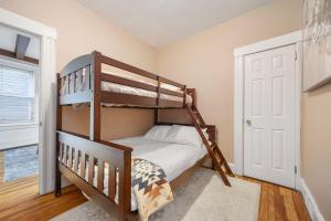 a bedroom with two bunk beds and a door at Spacious & Stylish 2BR Apartment Near Manhattan in Jersey City