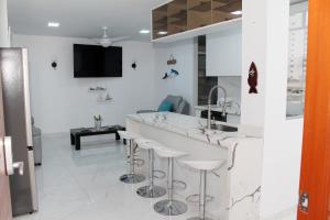 a white room with a bar with stools at Apartment in Ancon in Ancón