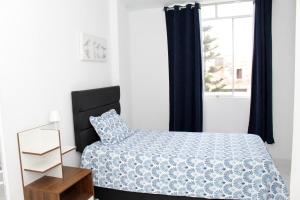 a small bedroom with a bed and a window at Apartment in Ancon in Ancón
