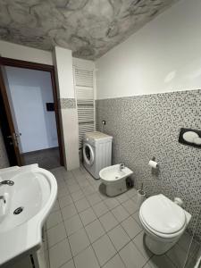 a bathroom with a toilet and a sink at Le Cinque Terre da Pippo in La Spezia +8 photos