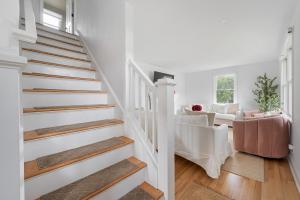 a white staircase in a home with a living room at Renovated Cape Near Beach with Fire Pit in Fairfield +72 photos