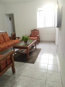 a living room with a couch and a coffee table at Conexão SP in São Paulo