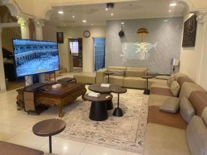 a living room with a couch and a large screen tv at دار ناصر in Riyadh