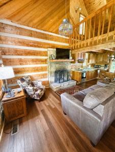 a living room with a couch and a fireplace at Ivy Retreat in Sevierville