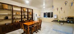 a kitchen with a dining table and a refrigerator at Tribus Hostel in Manaus