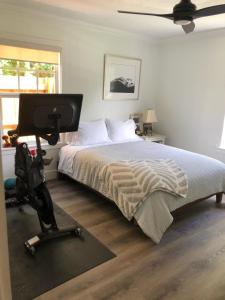 a bedroom with a bed and a desk with a computer at Northwood Revival in West Palm Beach