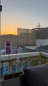 a view of a balcony with flowers on a building at Natalie Aqua villa heated pool 3BD DeadSea in Al Kafrayn